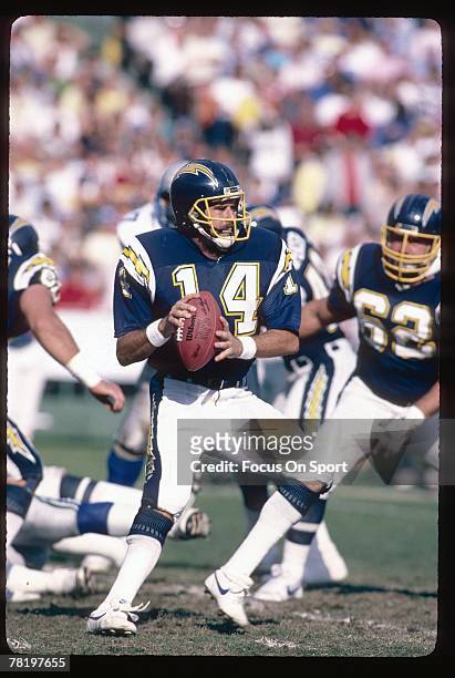 S: Dan Fouts of the San Diego Chargers drops back to pass against the Detroit Lions in an early 1980's NFL football game at Jack Murphy Stadium in...