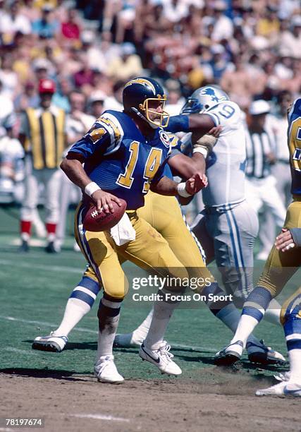 S: Dan Fouts of the San Diego Chargers drops back to pass against the Detroit Lions in an early 1980's NFL football game at Jack Murphy Stadium in...