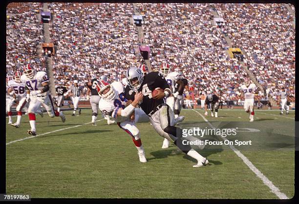 Running back Bo Jackson of the Los Angeles Raiders carries the ball during a circa late 1980's NFL game against the Buffalo Bills. Jackson played for...