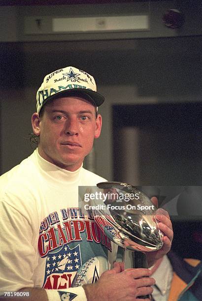 Troy Aikman of the Dallas Cowboys hold the Vince Lombardi trophy after defeating the Buffalo Bills in Superbowl XXVIII in the Georgia Dome in...