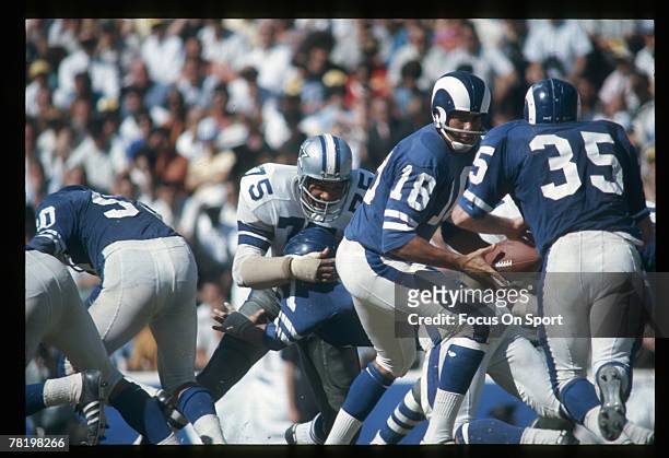 S: Quarterback Roman Gabriel of the Los Angeles Rams turns to hand the ball off against the Dallas Cowboys during a early circa 1970's NFL football...