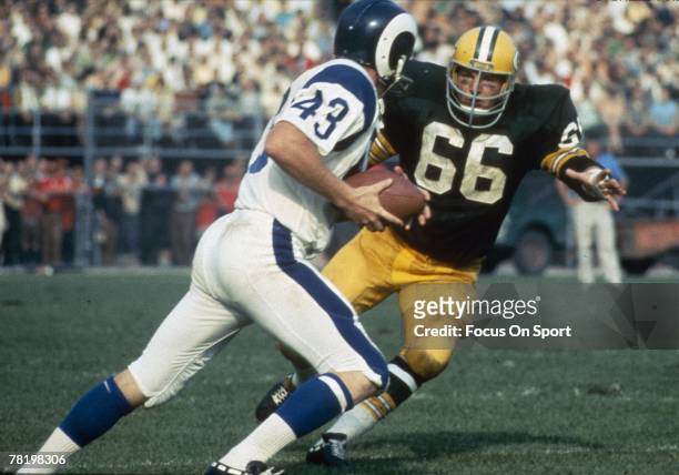 S: Linebacker Ray Nitschke of the Green Bay Packers chase down a Los Angeles Rams running-back during a circa 1960's NFL football game at Lambeau...
