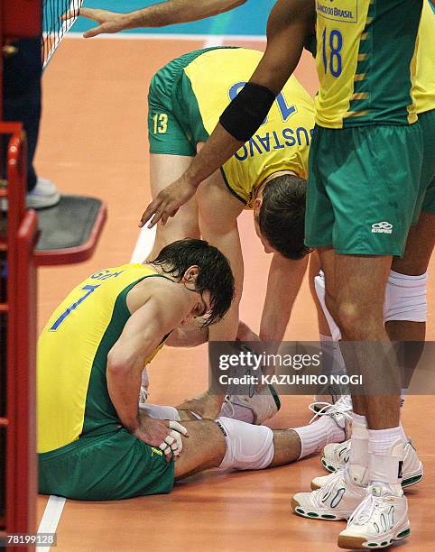 Brazilian volleyball star and captain Gilberto Godoy Filho "Giba" complains of pain on his left ankle during a match of the FIVB Men's World Cup...