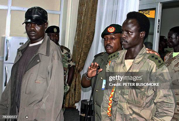 Lords's Resistance Army, LRA, captain, Sunday Otto [L] and Leutenant Richard Odong [4thL] are received in this 30 November 2007 photo, by Uganda...