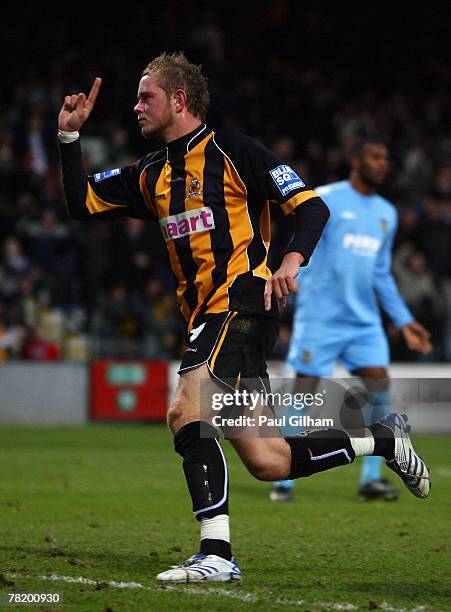 Scott Rendell of Cambridge United celebrates scoring the first goal for Cambridge United during the FA Cup sponsored by E.on 2nd round match between...