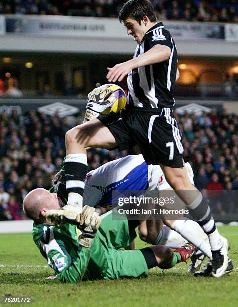 Joey Barton tries to beat Brad Friedel during a Barclays Premier League game between Blackburn Rovers and Newcastle United at Ewood Park on November...