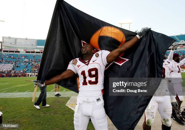 Split end Josh Hyman of the Virginia Tech Hokies celebrates with a Virginia Tech flag after defeating the Boston College Eagles in the ACC...