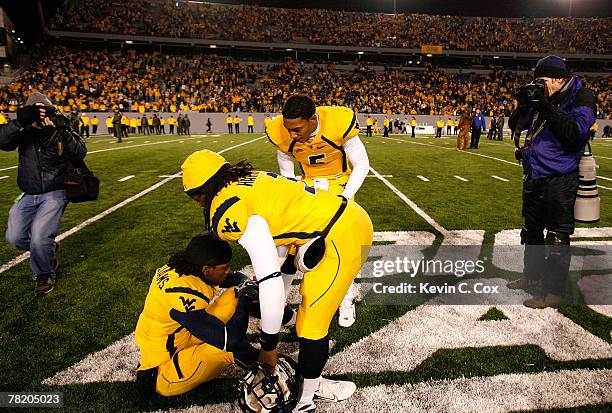 Quarterback Patrick White and Markell Harrison console Larry Williams of the West Virginia Mountaineers after their loss to the Pittsburgh Panthers...