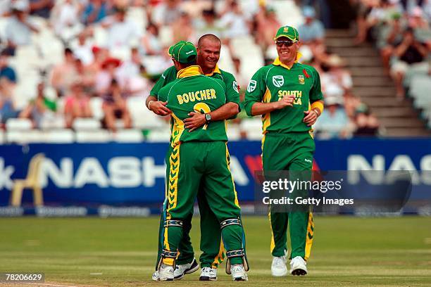 Charl Langeveldt of South Africa celebrates the wicket of Jamie How with team mate Mark Boucher during the third ODI match between South Africa and...