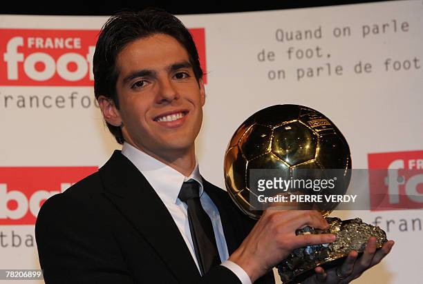 Milan's Brazilian midfielder Kaka poses with his trophy after being awarded as France Football's Player of the Year winning the prestigious Ballon...