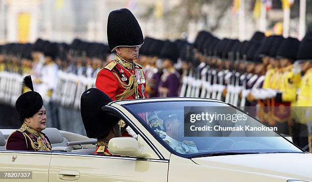 Thailand's King Bhumibol Adulyadej and Queen Sirikit review the honor guard during the Trooping of the colors to hornor the king's 80th birthday at...