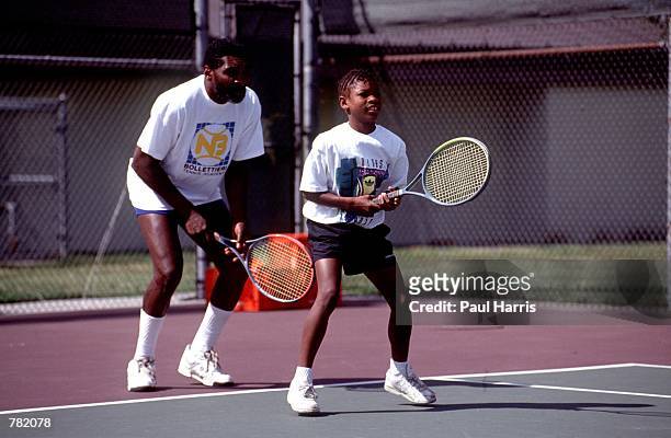 Richard Williams practices with his daughter, Serena in 1991 in Compton, CA. Serena and Venus Williams will be playing against each other for the...