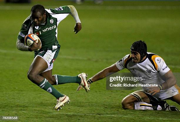 Topsy Ojo of Irish skips a tackle by Netani Talei of Worcester during the EDF Energy Cup group C match between London Irish and Worcester Warriors at...