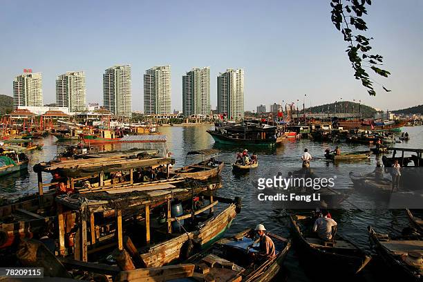 The fishing boats are parked in the Sanya Harbor on November 30, 2007 in Sanya of Hainan province, China. The real estate merchant builds up the...