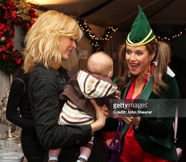 Actress Jenna Elfman, her son Story, and actress Kelly Preston backstage during the Church of Scientology's Christmas Stories XV benefiting the...