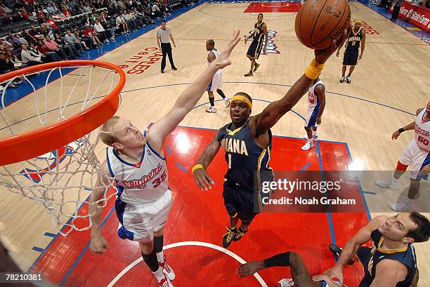 Jermaine O'Neal of the Indiana Pacers goes to the basket against Chris Kaman of the Los Angeles Clippers at Staples Center December 2, 2007 in Los...