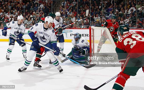 Byron Ritchie, Willie Mitchell, and Roberto Luongo of the Vancouver Canucks defends their goal while Pavol Demitra, Marian Gaborik, and Brian Rolston...