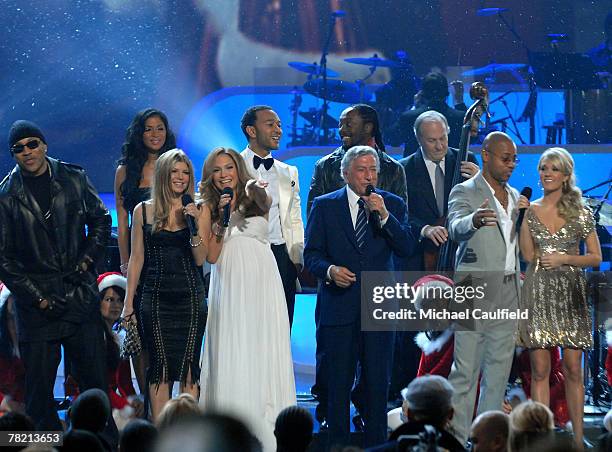 Singer Tony Bennett is joined onstage for "White Christmas" by LL Cool J, Nicole Sherzinger, Fergie, Jennifer Lopez, John Legend, will.i.am, Cuba...