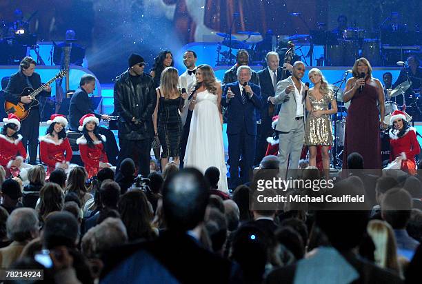 Singer Tony Bennett is joined onstage for "White Christmas" by LL Cool J, Nicole Sherzinger, Fergie, Jennifer Lopez, John Legend, will.i.am, Cuba...