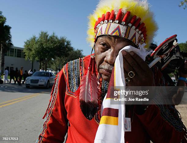 Washington Redskins "unofficial" mascot Zema Williams known as Chief Zee wipes his face as he arrives for the funeral of Redskins football player,...