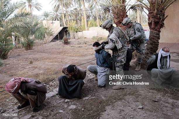 Iraqi males are blindfolded by U.S. Soldiers in the 4th Stryker Brigade, 2nd Infantry out of Ft. Lewis, Washington, during a raid December 3, 2007 in...