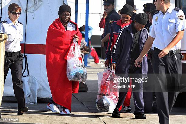 Some of the 59 would be immigrants, who arrived on the coast of Canary island, walk escorted by policemen 03 December 2007, after their "cayucos" had...