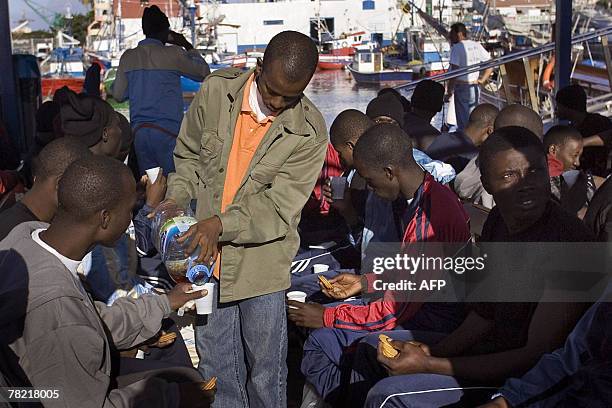 Some of the 59 would be immigrants, who arrived on the coast of Canary island, have a snack and refresh as they wait 03 December 2007, after their...