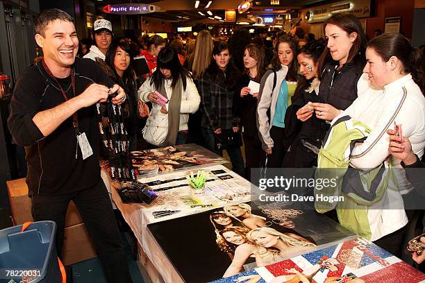 Fans buy merchandise prior to the Spice Girls' performance on stage on the opening night of the reunited group's 2007 World Tour at General Motors...