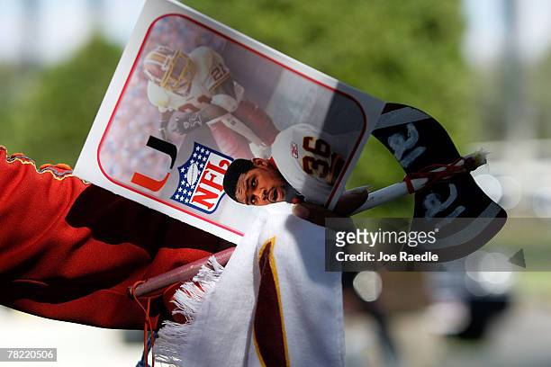 Washington Redskins "unofficial" mascot Zema Williams known as Chief Zee holds a funeral program as he attends the funeral of Redskins football...