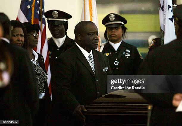 The casket of Washington Redskins football player Sean Taylor is wheeled out to the hearse during his funeral at the Pharmed Arena at Florida...