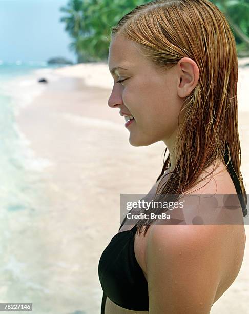 portrait of young teenage woman (16-19 years) in bikini on the beach - blonde girl wet hair stock pictures, royalty-free photos & images