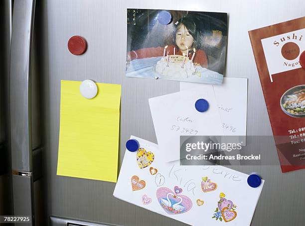 different notes pinned on door of refrigerator - magnet stock pictures, royalty-free photos & images