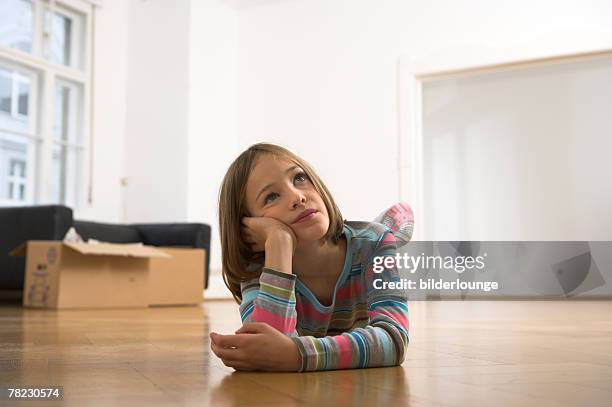 little girl looking unhappy around her in new home - suspicious package stock pictures, royalty-free photos & images