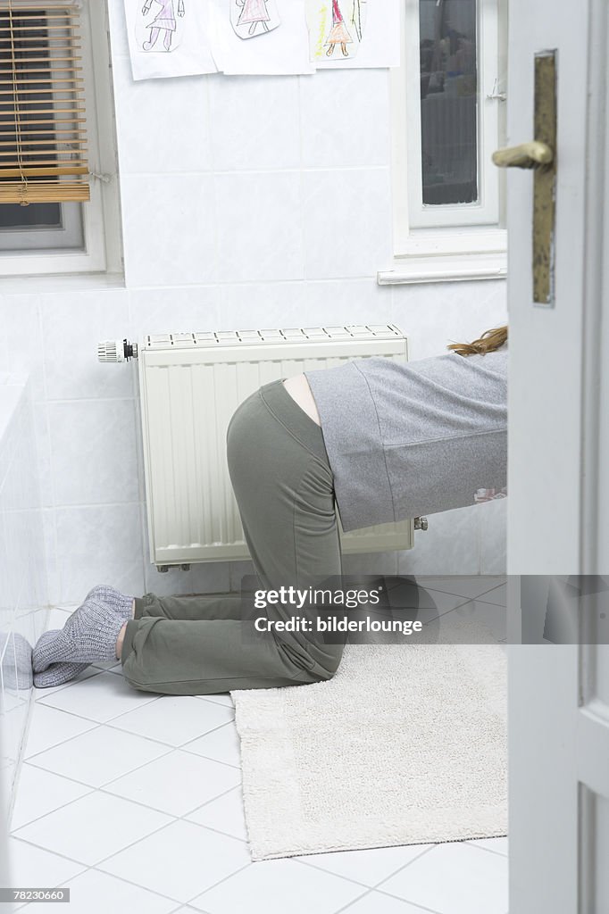 Young woman leaning over toilet vomiting