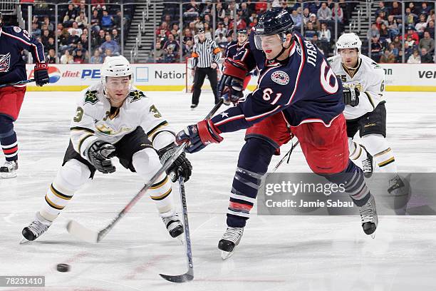 Rick Nash of the Columbus Blue Jackets snaps off a shot as Stephane Robidas of the Dallas Stars defends on December 3, 2007 at Nationwide Arena in...