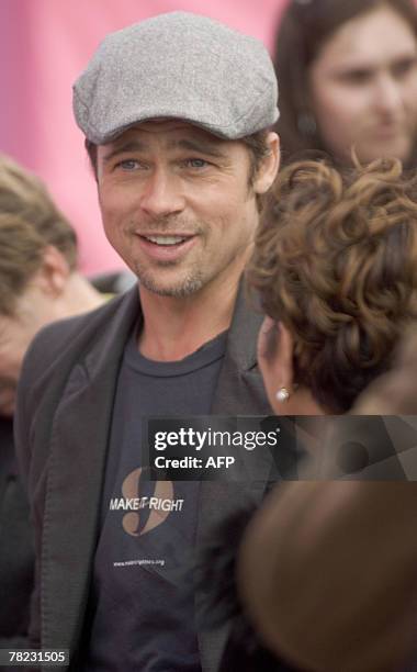 Actor Brad Pitt speaks with local politicians prior to a press conference about his plans to spend USD12 million with his "Make It Right Project" to...