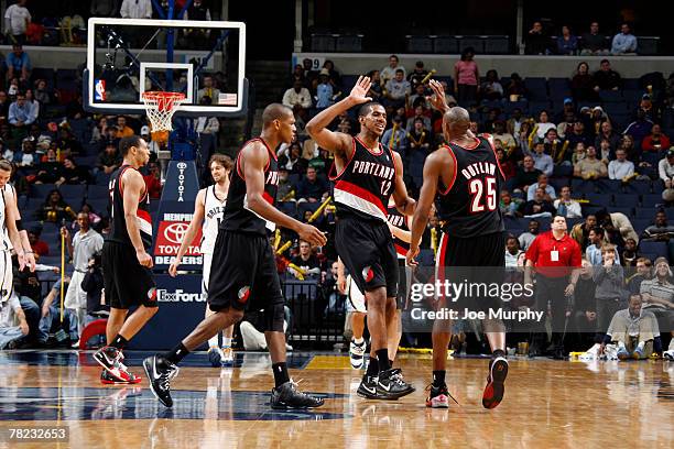 Travis Outlaw celebrates with teammates LaMarcus Aldridge and James Jones of the Portland Trail Blazers on his three point shot to tie the game...