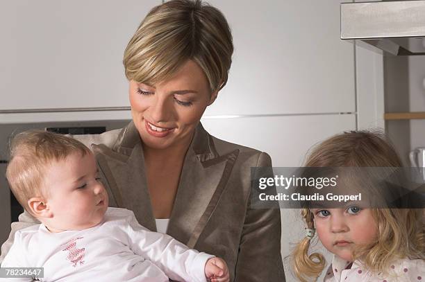 young businesswoman with her daughters one looking moody - claudia neidig stock-fotos und bilder