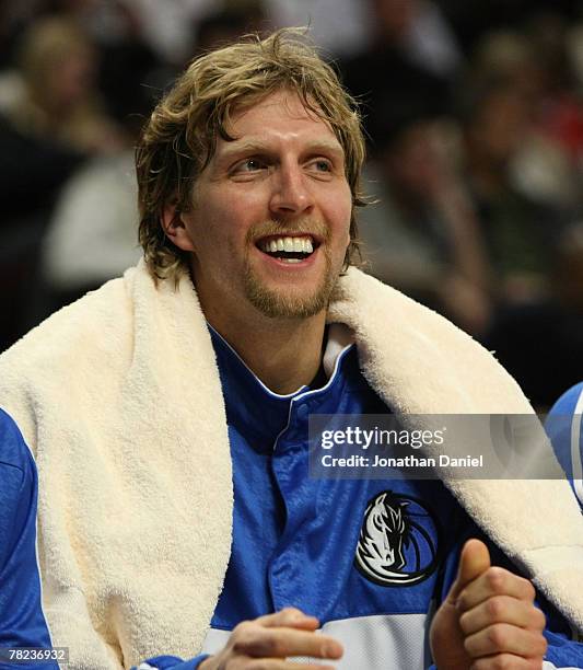 Dirk Nowitzki of the Dallas Mavericks watches from the bench as his teammates play against the Chicago Bulls at the United Center December 3, 2007 in...