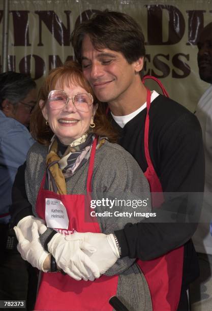 Actor Tony Danza hugs Katherine Helmond as they prepare to help serve free dinners to the homeless at the Los Angeles Mission during "The Great...