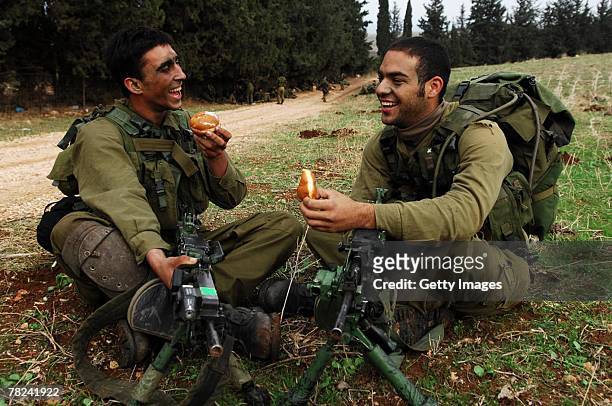 In this photograph distributed by the Israeli Defense Forces , infantry soldiers from the elite Egoz unit take a break from operational duty to eat...