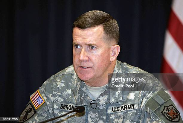 Major General Kevin Bergner , spokesman for Multinational Forces Iraq, speaks as a picture of the is shown on a tv screen during a press conference...