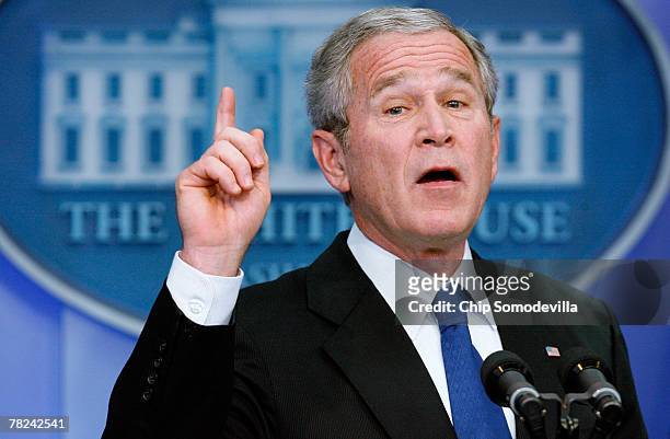 President George W. Bush answers questions from reporters during a press conference in the Brady Press Briefing Room at the White House December 4,...