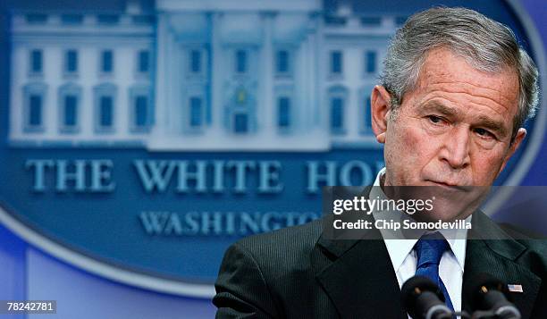 President George W. Bush listens to questions from reporters during a press conference in the Brady Press Briefing Room at the White House December...