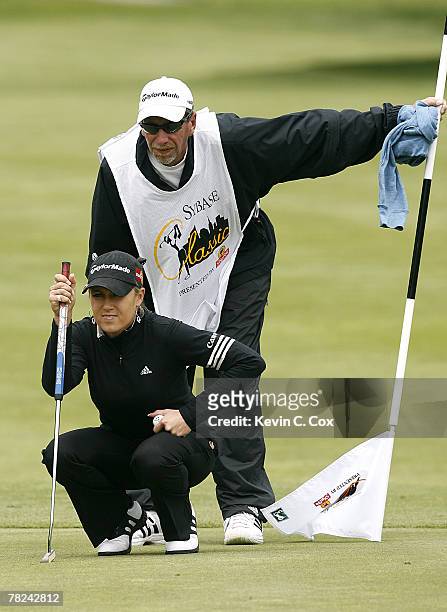 Natalie Gulbis and her caddie line up her birdie putt on the fourth green during the second round of the 2007 Sybase Classic Presented by ShopRite at...
