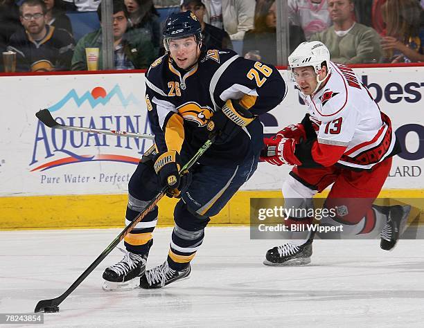 Thomas Vanek of the Buffalo Sabres skates away from Ray Whitney of the Carolina Hurricanes on December 1, 2007 at HSBC Arena in Buffalo, New York.