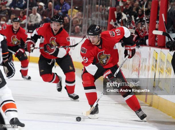 Jason Spezza of the Ottawa Senators stick-handles his way into the offensive zone with team-mate Dany Heatley supporting against the Philadelphia...