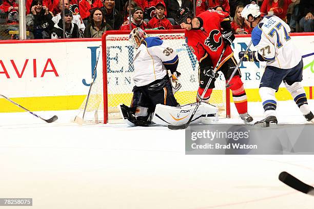 Marcus Nilson of the Calgary Flames is stopped by Hannu Toivonen of the St. Louis Blues on December 4, 2007 at Pengrowth Saddledome in Calgary,...