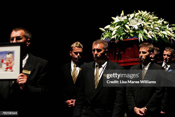 Pallbearers carry the coffin of the late Bernard Douglas 'Bernie' Banton during his State Funeral at Acer Arena on December 5, 2007 in Sydney,...