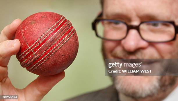 Peter Young of Cricket Australia holds up the ball that Australian batsman Adam Gilchrist hit for his 100th Test six, a world record, and which was...